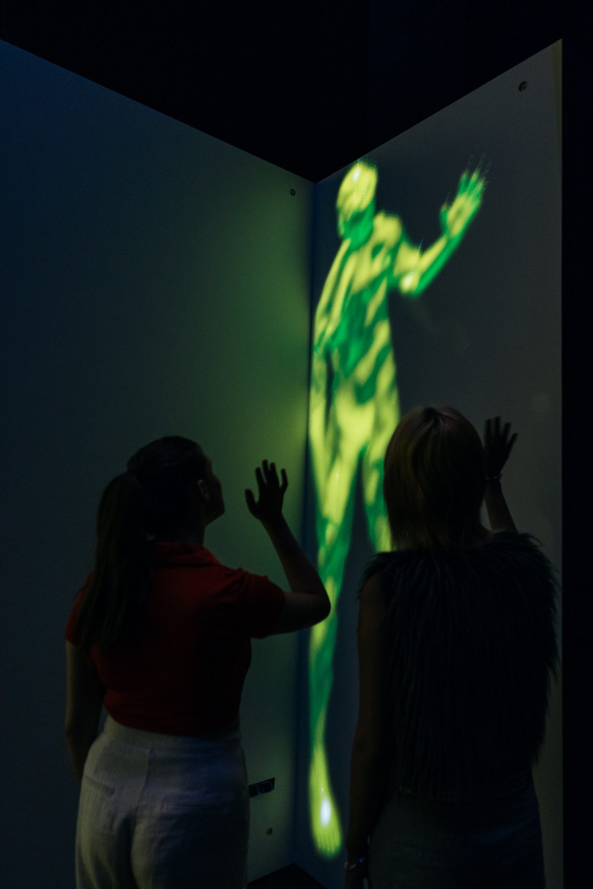 Visitor interacting with projected version of themselves