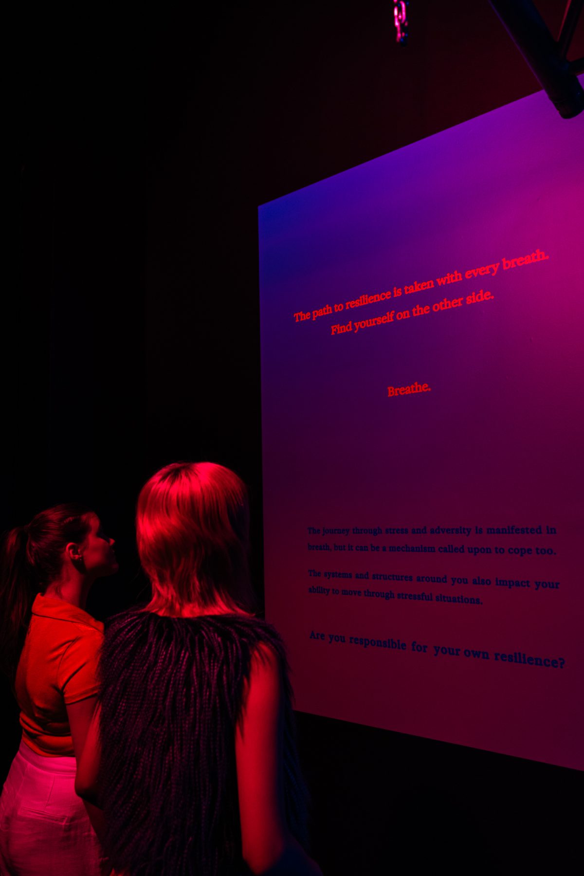 Visitors reading the entrance text to BREATHE