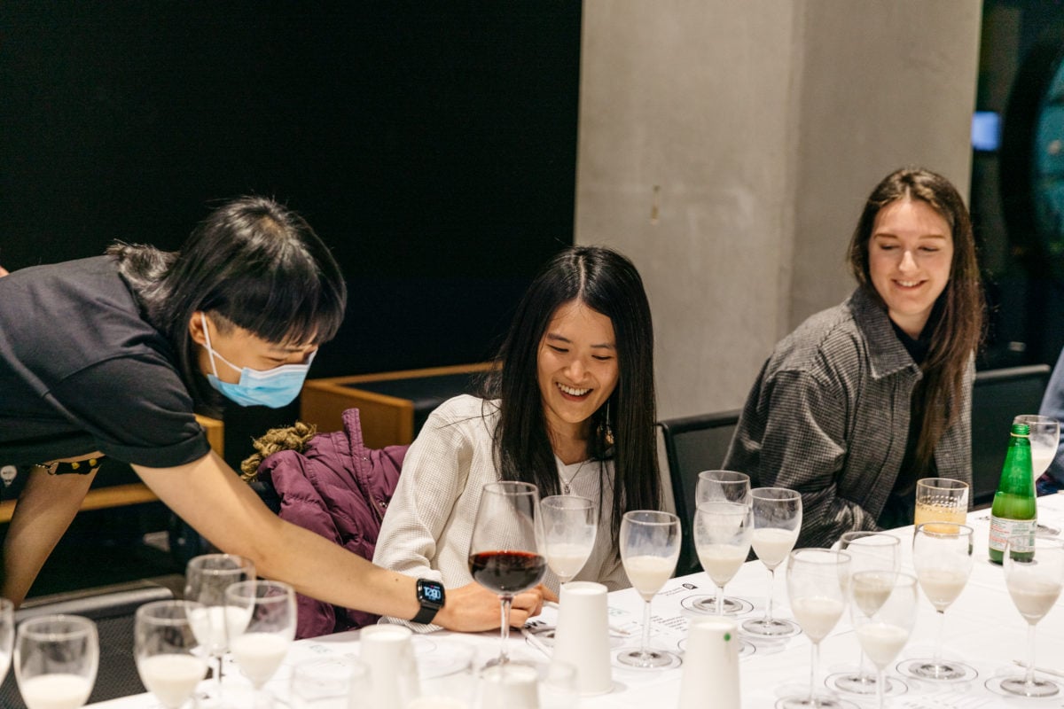 Three young women comparing milk samples to look at the ethics of plant-based milks