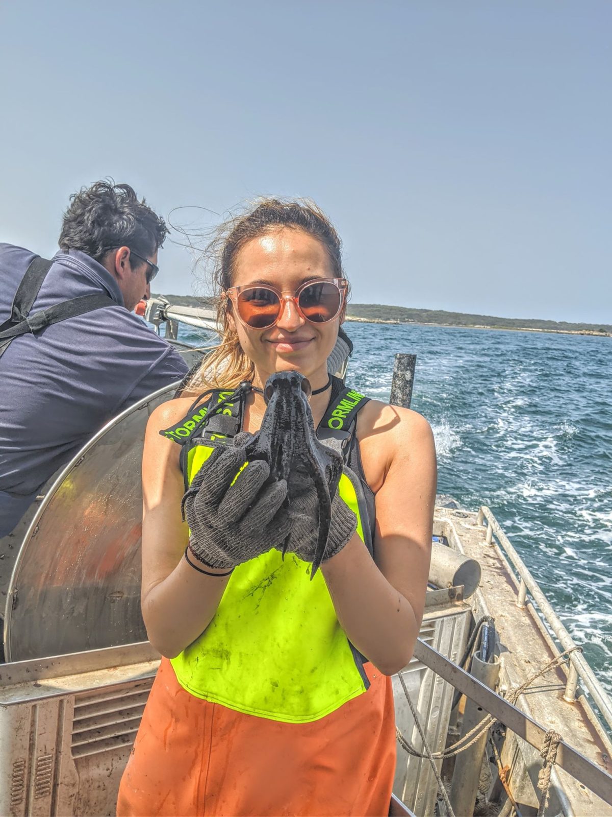 Jasmin holding an octopus on a boat